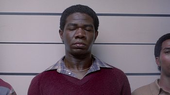 Movie still from “Witness” (1985), directed by Peter Weir – A man with his eyes closed standing in front of a wall; Close Up shot, Low angle