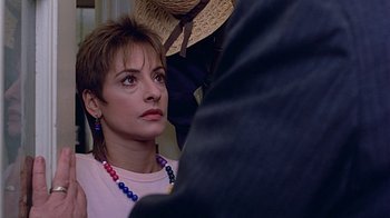Movie still from “Witness” (1985), directed by Peter Weir – A person wearing a hat and a necklace; Close Up shot, Over the shoulder angle