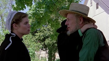 Movie still from “Witness” (1985), directed by Peter Weir – A man and a woman talking to each other outside; Close Up shot, Over the shoulder angle