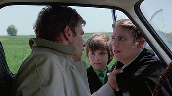 Movie still from “Witness” (1985), directed by Peter Weir – A man and a woman and a child in a car; Close Up shot, Over the shoulder angle