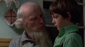 Movie still from “Witness” (1985), directed by Peter Weir – An older man and a young boy looking at each other; Close Up shot, Over the shoulder angle