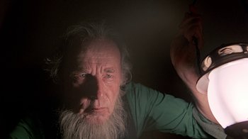 Movie still from “Witness” (1985), directed by Peter Weir – An old man with long white hair and a long beard; Close Up shot, Low angle