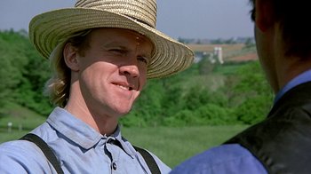 Movie still from “Witness” (1985), directed by Peter Weir – A person wearing a straw hat; Close Up shot, Over the shoulder angle