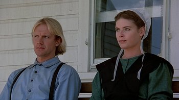 Movie still from “Witness” (1985), directed by Peter Weir – A man and a woman standing next to each other; Close Up shot, Low angle