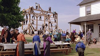 Movie still from “Witness” (1985), directed by Peter Weir – A group of people standing on top of a wooden structure; Extreme Wide shot, High angle