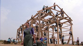 Movie still from “Witness” (1985), directed by Peter Weir – A group of people standing on top of a wooden structure; Extreme Wide shot, Low angle