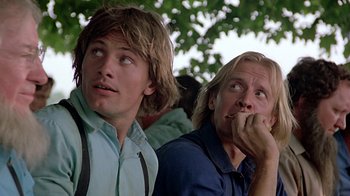 Movie still from “Witness” (1985), directed by Peter Weir – A couple of men standing next to each other; Close Up shot, Low angle