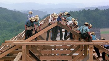 Movie still from “Witness” (1985), directed by Peter Weir – A group of men standing on top of a wooden structure; Extreme Wide shot, Low angle