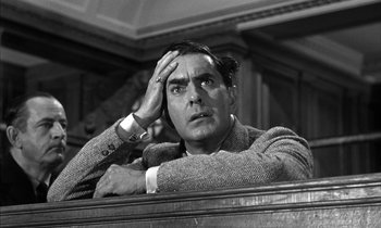 Movie still from “Witness for the Prosecution” (1957), directed by Billy Wilder – A black - and - white photo of a man in a courtroom; Close Up shot, Low angle