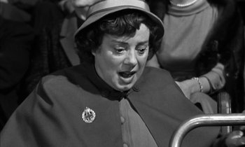 Movie still from “Witness for the Prosecution” (1957), directed by Billy Wilder – An old photo of a woman with a hat on; Close Up shot, High angle