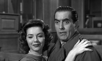 Movie still from “Witness for the Prosecution” (1957), directed by Billy Wilder – An older man and woman posing for a picture; Close Up shot, Over the shoulder angle