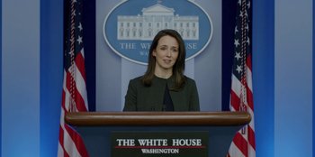 Movie still from “House of Cards” (2013), created by Beau Willimon – A woman standing at a podium in front of the white house; Close Up shot, Low angle