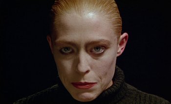 Movie still from “Wittgenstein” (1993), directed by Derek Jarman – A person with blonde hair; Close Up shot, Low angle