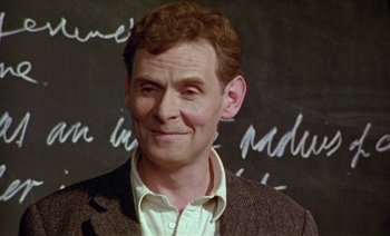 Movie still from “Wittgenstein” (1993), directed by Derek Jarman – A person wearing a jacket; Close Up shot, Low angle