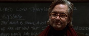 Movie still from “Wonder Boys” (2000), directed by Curtis Hanson – A man wearing glasses and a scarf standing in front of a blackboard; Close Up shot, Low angle