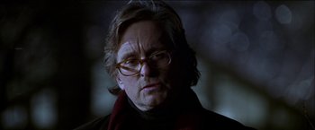 Movie still from “Wonder Boys” (2000), directed by Curtis Hanson – A person wearing glasses and a scarf; Close Up shot, Over the shoulder angle