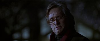 Movie still from “Wonder Boys” (2000), directed by Curtis Hanson – An older man wearing glasses and a red scarf; Close Up shot, Low angle