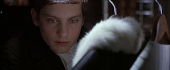 Movie still from “Wonder Boys” (2000), directed by Curtis Hanson – A young man looking into the camera while wearing headphones; Close Up shot, Over the shoulder angle