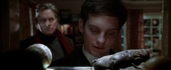 Movie still from “Wonder Boys” (2000), directed by Curtis Hanson – A young man looking down at his face in a dark room; Close Up shot, Low angle