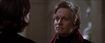 Movie still from “Wonder Boys” (2000), directed by Curtis Hanson – An older man wearing a black shirt and a red scarf; Close Up shot, Over the shoulder angle