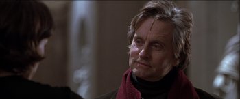 Movie still from “Wonder Boys” (2000), directed by Curtis Hanson – An older man wearing a red scarf looking at the camera; Close Up shot, Over the shoulder angle