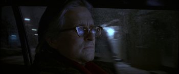 Movie still from “Wonder Boys” (2000), directed by Curtis Hanson – An old man wearing glasses looking at the camera; Close Up shot, Over the shoulder angle