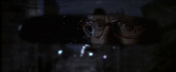 Movie still from “Wonder Boys” (2000), directed by Curtis Hanson – A woman wearing glasses looking through a window; Extreme Close Up shot, Over the shoulder angle
