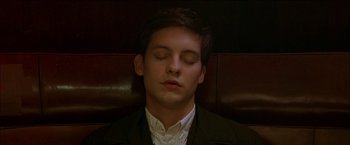 Movie still from “Wonder Boys” (2000), directed by Curtis Hanson – A man with his eyes closed sitting in a chair; Close Up shot, High angle