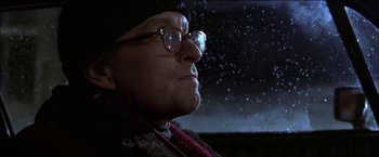 Movie still from “Wonder Boys” (2000), directed by Curtis Hanson – An older man wearing glasses and a hat looking out a window; Close Up shot, Low angle