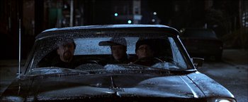 Movie still from “Wonder Boys” (2000), directed by Curtis Hanson – Three people in a car in the rain at night; Medium shot, Low angle