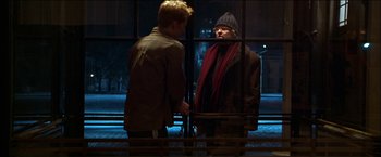 Movie still from “Wonder Boys” (2000), directed by Curtis Hanson – Two men standing next to each other in front of a window; Medium shot, Over the shoulder angle