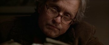 Movie still from “Wonder Boys” (2000), directed by Curtis Hanson – An older man wearing glasses and reading a book; Close Up shot, Low angle