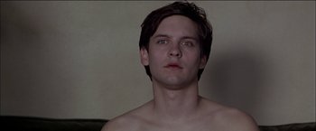 Movie still from “Wonder Boys” (2000), directed by Curtis Hanson – A man with a bare - chested face looking at the camera; Close Up shot, Low angle