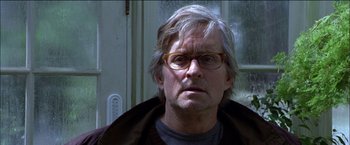 Movie still from “Wonder Boys” (2000), directed by Curtis Hanson – An older man wearing glasses and a brown jacket; Close Up shot, Low angle