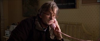 Movie still from “Wonder Boys” (2000), directed by Curtis Hanson – An older man talking on a pink phone; Close Up shot, Low angle