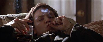 Movie still from “Wonder Boys” (2000), directed by Curtis Hanson – A man smoking a cigarette while laying down; Close Up shot, Low angle