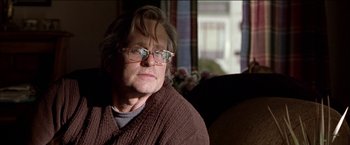 Movie still from “Wonder Boys” (2000), directed by Curtis Hanson – An older man wearing glasses sitting in a chair; Close Up shot, Low angle