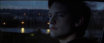 Movie still from “Wonder Boys” (2000), directed by Curtis Hanson – A man looking out of a window at night; Close Up shot, Low angle