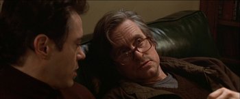 Movie still from “Wonder Boys” (2000), directed by Curtis Hanson – A man sitting next to another man on a couch; Close Up shot, Over the shoulder angle