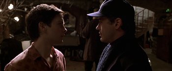 Movie still from “Wonder Boys” (2000), directed by Curtis Hanson – Two young men talking to each other in a dark room; Close Up shot, Over the shoulder angle