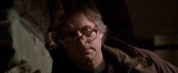 Movie still from “Wonder Boys” (2000), directed by Curtis Hanson – An older man wearing glasses and a brown jacket; Close Up shot, Low angle