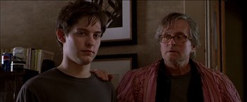 Movie still from “Wonder Boys” (2000), directed by Curtis Hanson – A man standing next to another man in front of a picture; Close Up shot, Low angle