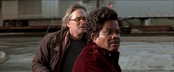 Movie still from “Wonder Boys” (2000), directed by Curtis Hanson – A man standing next to another man in front of a building; Close Up shot, Over the shoulder angle
