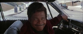 Movie still from “Wonder Boys” (2000), directed by Curtis Hanson – An older man sitting in the driver's seat of a car; Close Up shot, Low angle