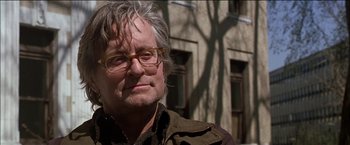 Movie still from “Wonder Boys” (2000), directed by Curtis Hanson – An older man wearing glasses standing in front of a building; Close Up shot, Low angle