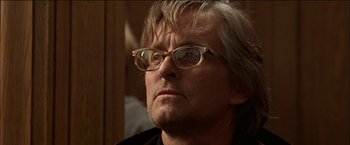 Movie still from “Wonder Boys” (2000), directed by Curtis Hanson – An older man wearing glasses looking at the camera; Close Up shot, Low angle