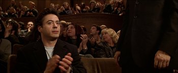 Movie still from “Wonder Boys” (2000), directed by Curtis Hanson – A crowd of people sitting in a room; Medium shot, High angle