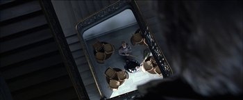 Movie still from “Wonder Boys” (2000), directed by Curtis Hanson – Looking up at a mirror with a man sitting on the ground; Wide shot, Overhead angle