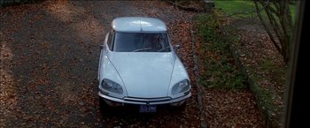 Movie still from “Wonder Boys” (2000), directed by Curtis Hanson – An old car is parked on the side of the road; Wide shot, High angle