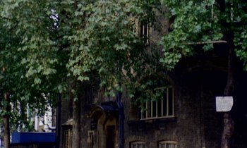 A brick building with a tree in front of it